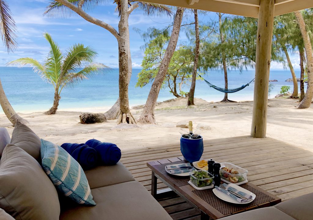 Traditional Fijian picnic surrounded by the island’s lush tropical scenery.