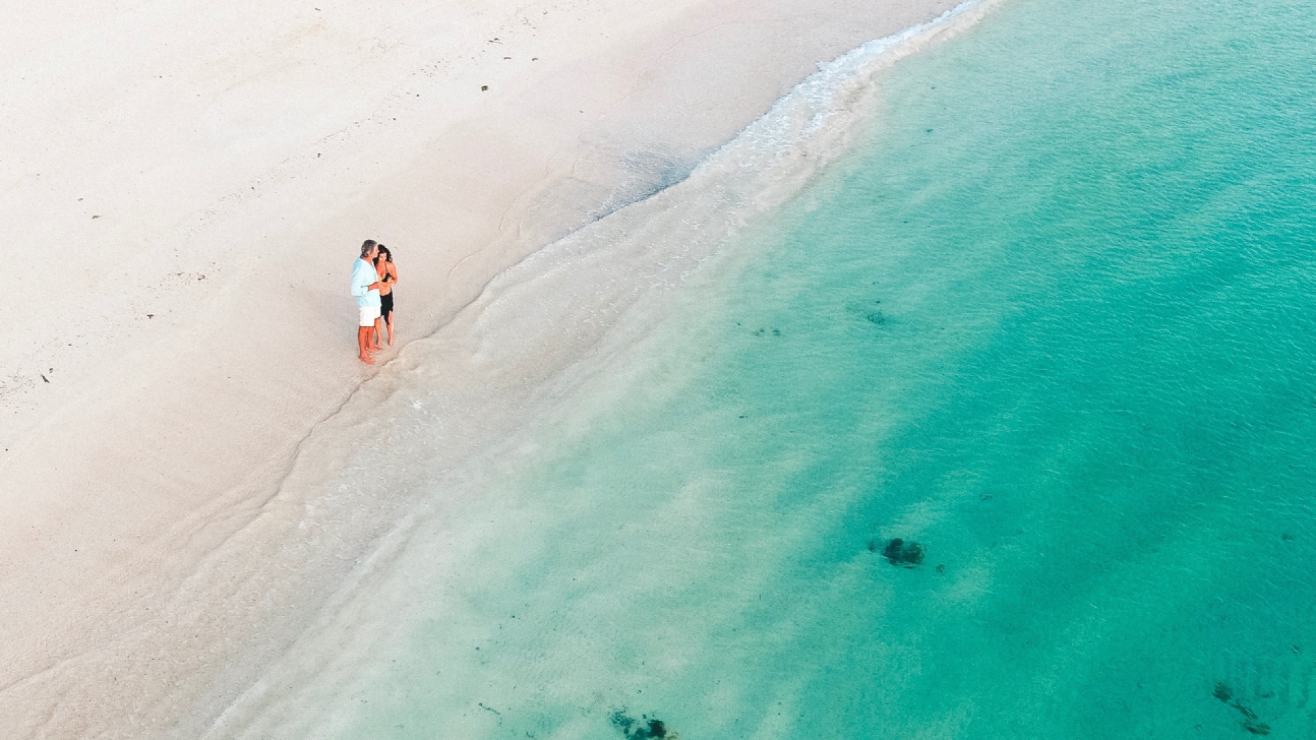 A honeymoon couple overlooking the turquoise ocean in Fiji
