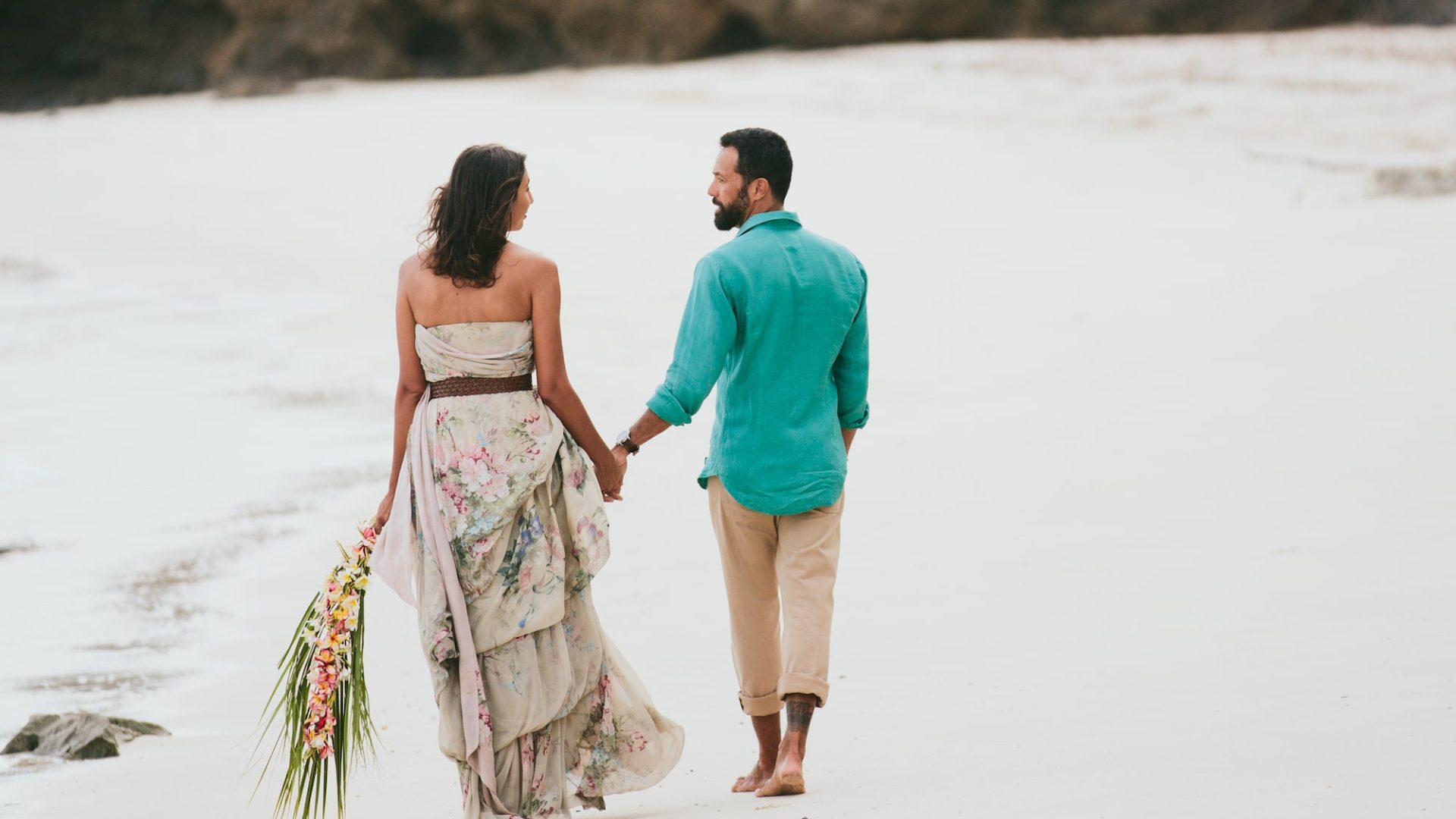 Couple on a paradise island in Fiji with white sand beach and turquoise waters